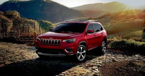 A red 2019 Jeep Cherokee parked in the hills near Wichita, KS