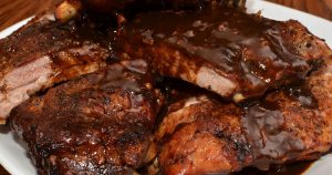 A large plate full of barbecued meat.
