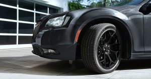 The 2019 Chrysler 300 in black parked in front of a garage door in Wichita, KS