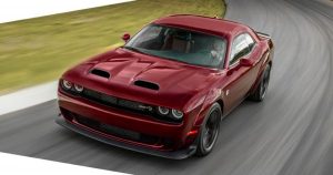 A dark red 2019 Dodge Challenger Hellcat SRT driving on a race course near Wichita, KS
