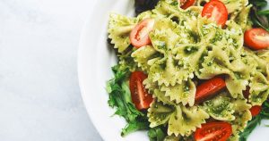 A plate of bow tie pasta with pesto sauce at a restaurant in Wichita, KS